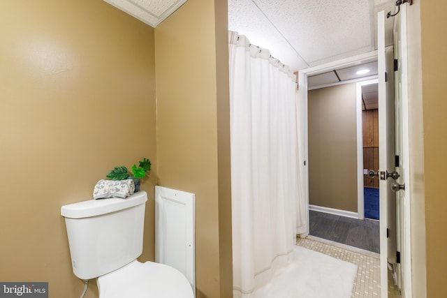 bathroom with toilet and crown molding