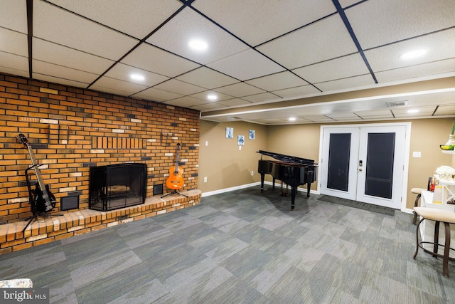 rec room with carpet flooring and a brick fireplace