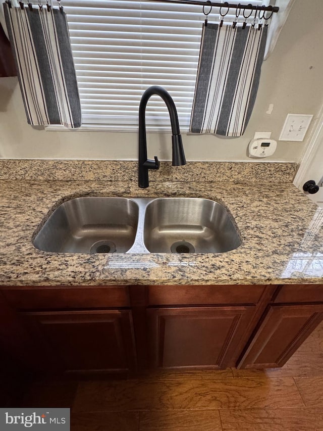 details featuring light stone counters and sink