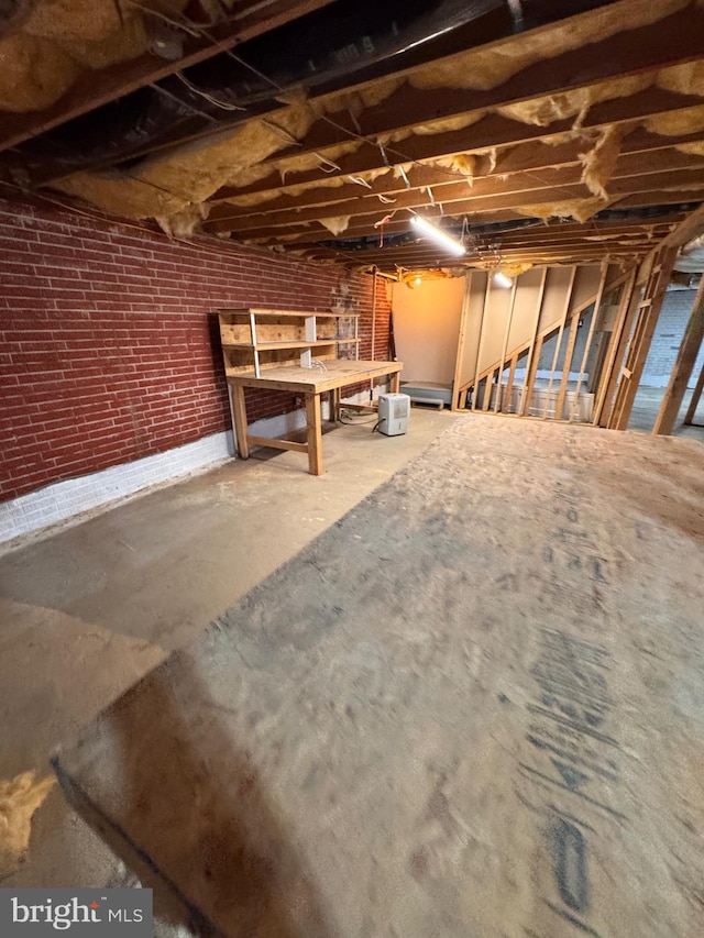 basement with brick wall