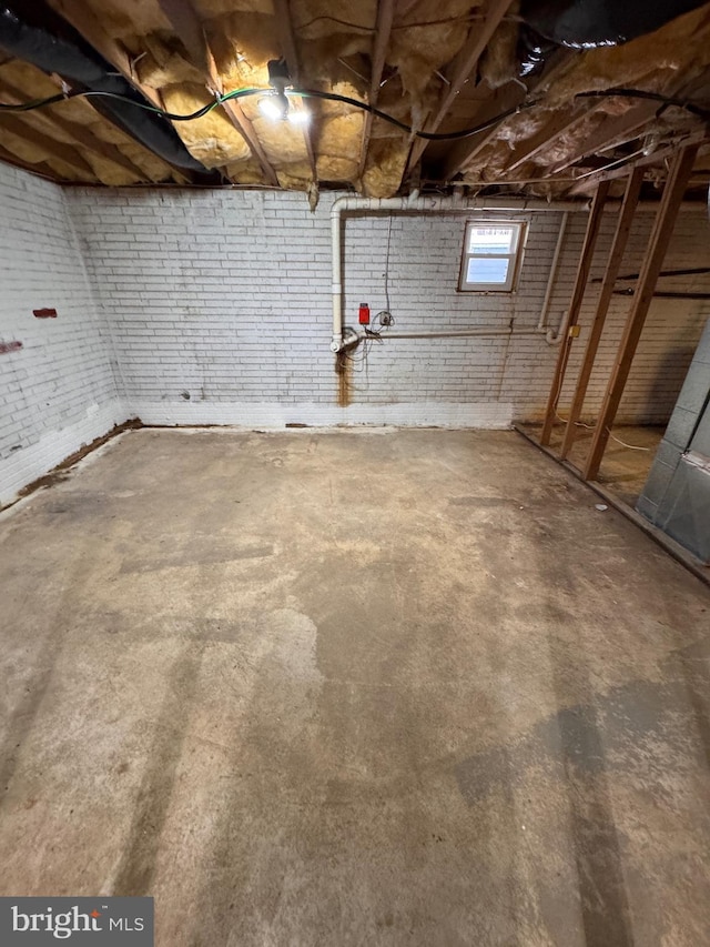 basement with brick wall