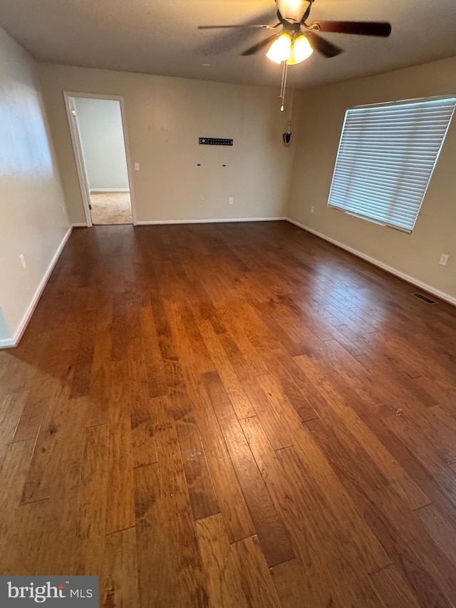 spare room with hardwood / wood-style floors and ceiling fan