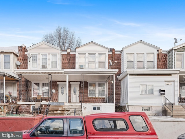 townhome / multi-family property featuring a porch