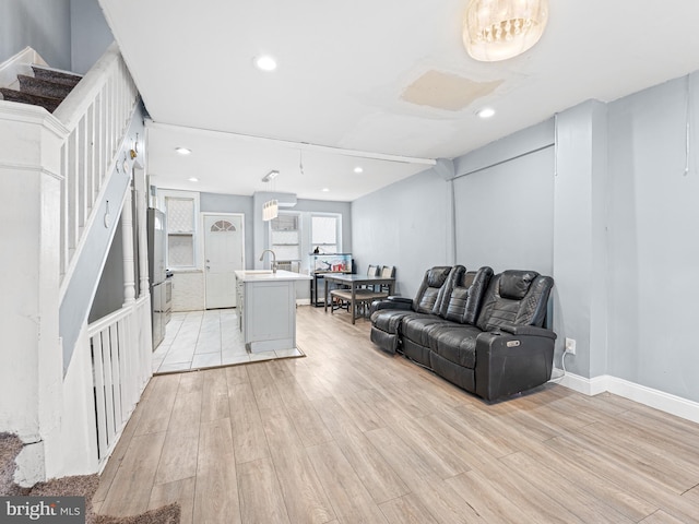 living room featuring sink and light wood-type flooring