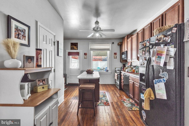 interior space featuring dark wood-style floors and a ceiling fan