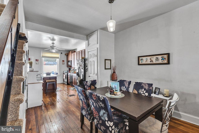 dining area with hardwood / wood-style flooring and baseboards