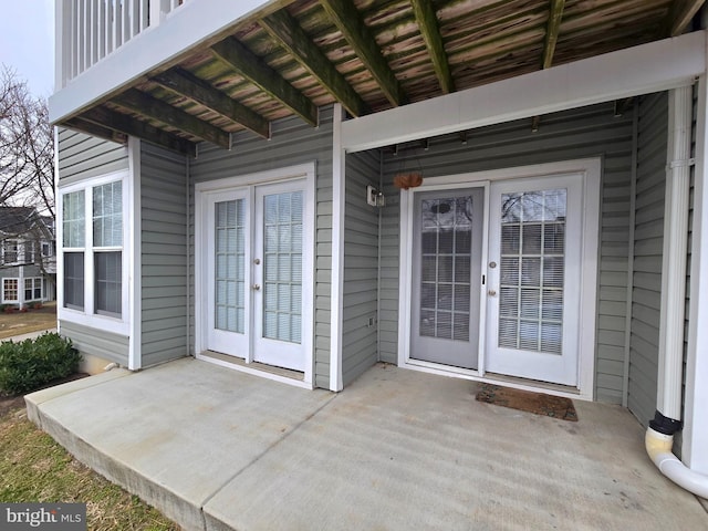 property entrance featuring french doors and a patio area