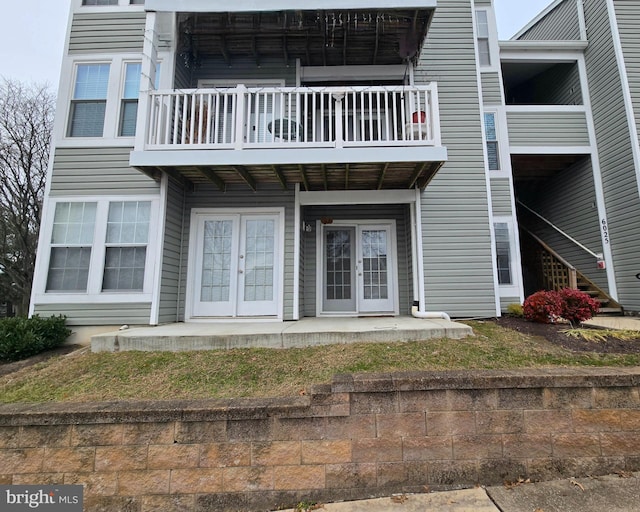 rear view of house featuring french doors and a balcony