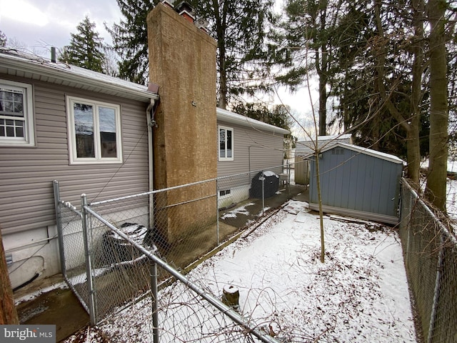 view of snow covered exterior featuring a storage unit