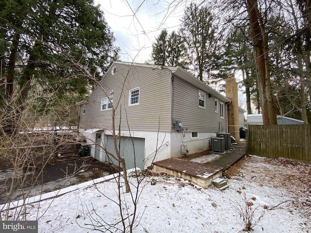 view of snow covered exterior with central air condition unit