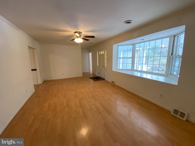 unfurnished room with ceiling fan and light wood-type flooring