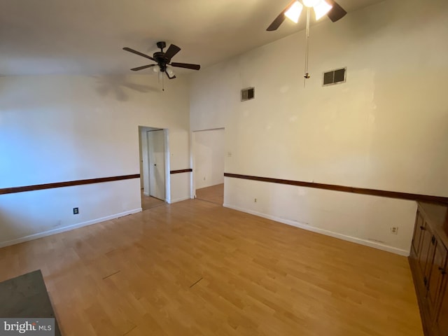 spare room featuring ceiling fan, light hardwood / wood-style flooring, and high vaulted ceiling