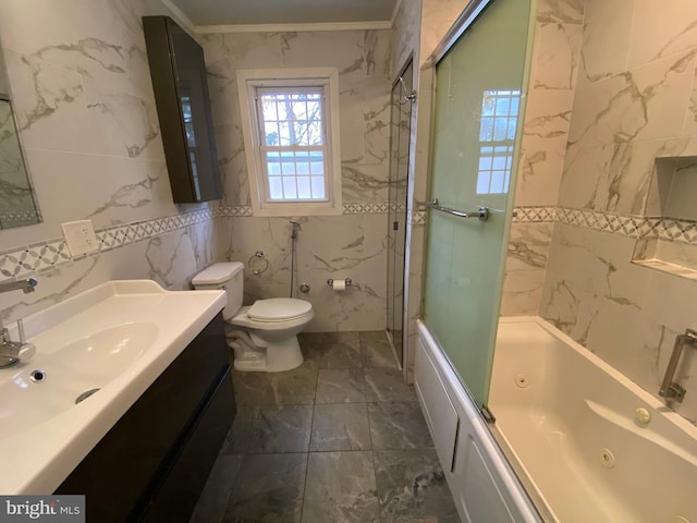 full bathroom with toilet, tile walls, crown molding, enclosed tub / shower combo, and vanity