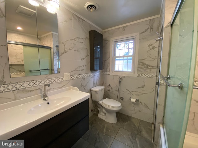 bathroom with toilet, tile walls, baseboard heating, ornamental molding, and vanity