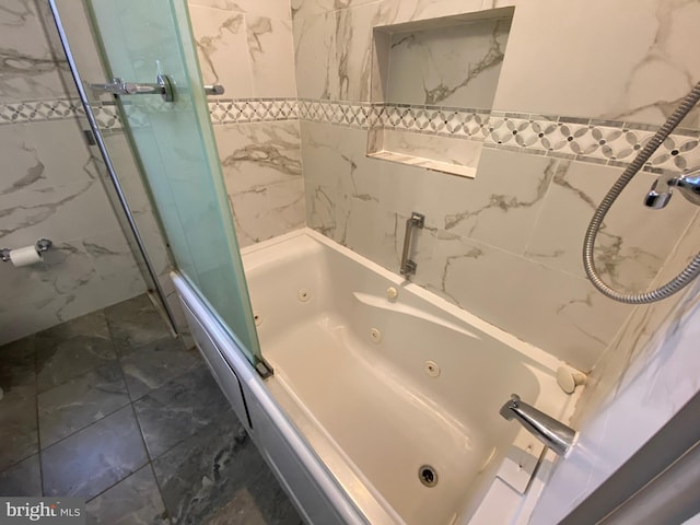 bathroom featuring shower / bath combination with glass door