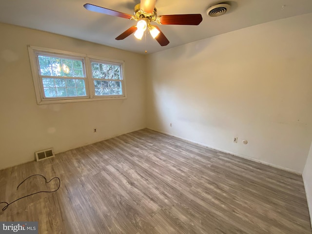 spare room with ceiling fan and hardwood / wood-style flooring