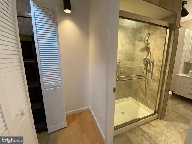 bathroom with toilet and a shower with shower door