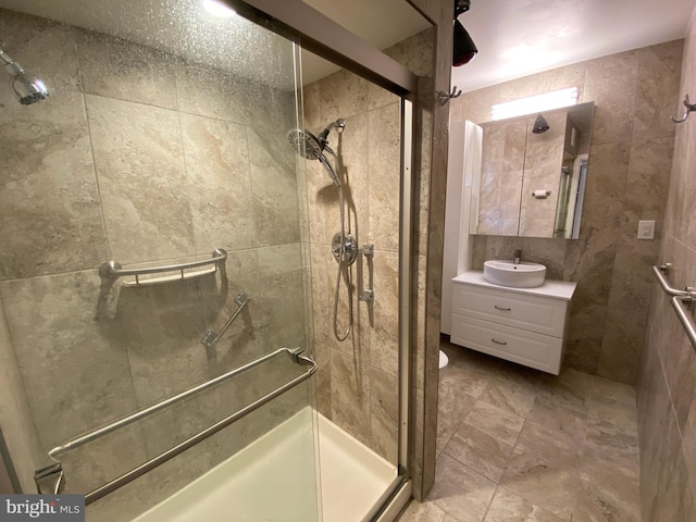 bathroom with a shower with door and vanity