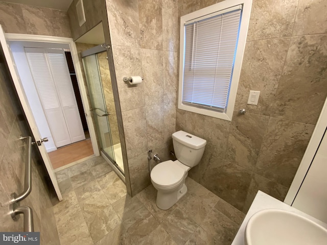 bathroom featuring sink, walk in shower, and toilet