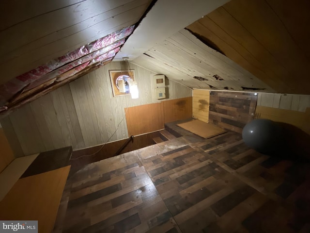 additional living space with wooden walls and lofted ceiling