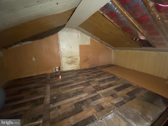 additional living space with lofted ceiling and wooden walls