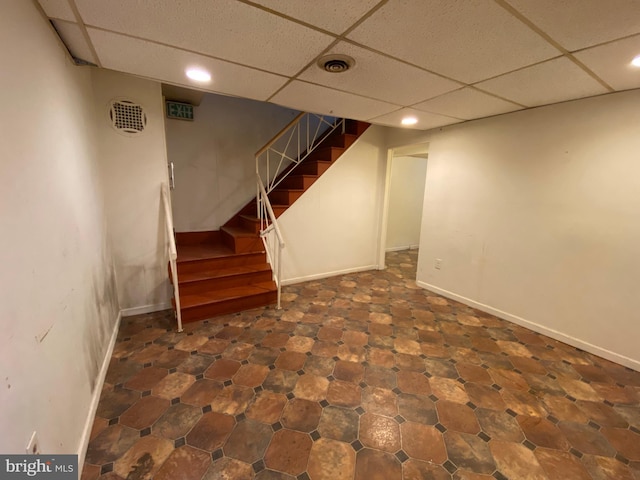 basement featuring a paneled ceiling