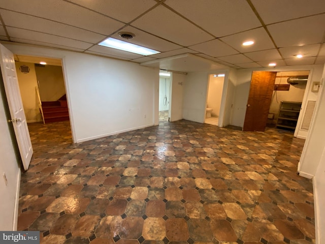 basement featuring a drop ceiling