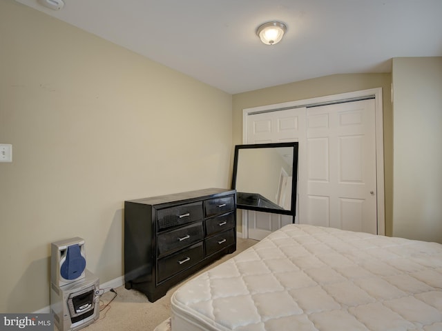 bedroom featuring light colored carpet and a closet