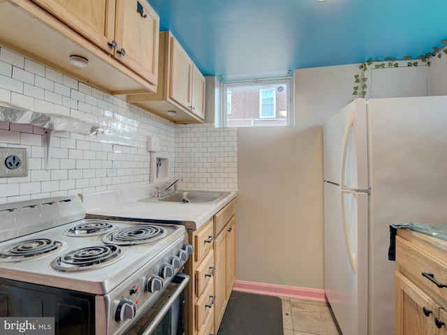 kitchen featuring white fridge, decorative backsplash, electric stove, sink, and light tile patterned floors