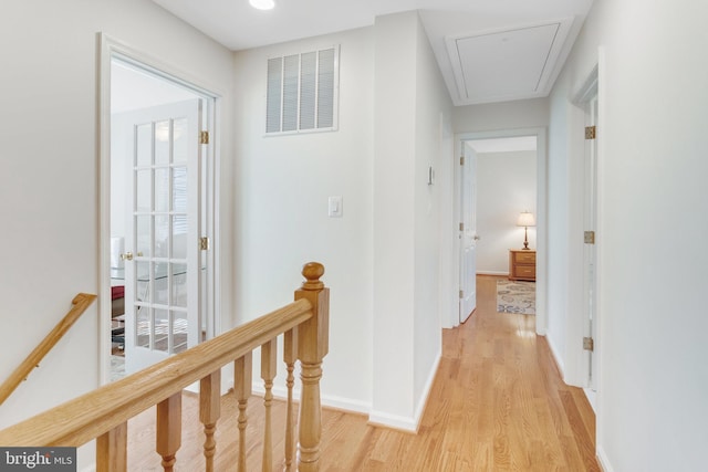 hallway with light hardwood / wood-style floors