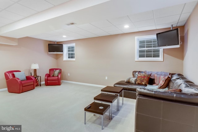 carpeted living room featuring a paneled ceiling