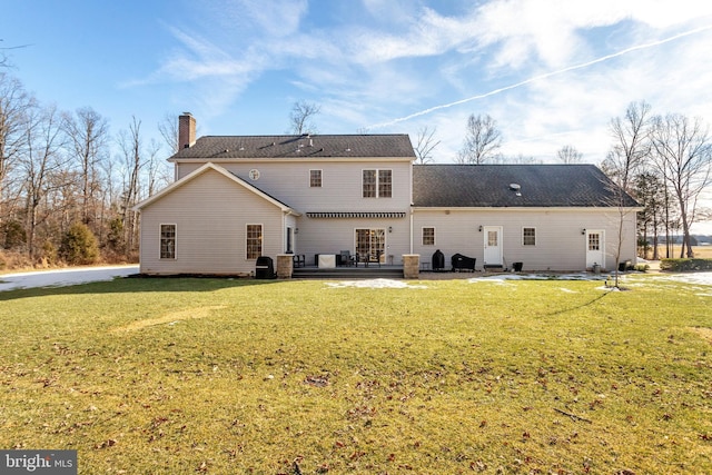 rear view of house with a lawn