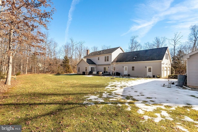 rear view of house featuring a yard