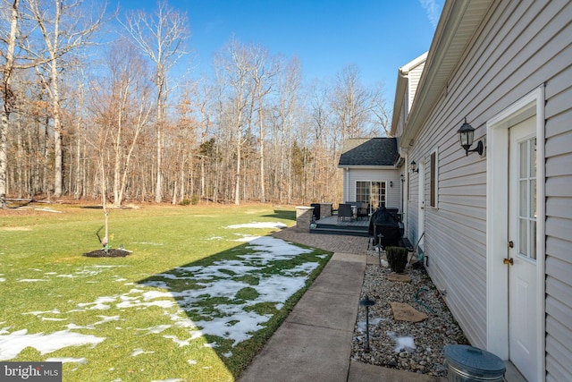 view of yard featuring a wooden deck and a patio