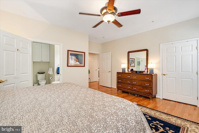 bedroom with ceiling fan, light hardwood / wood-style floors, and ensuite bathroom