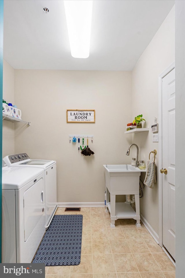 laundry room with light tile patterned flooring and independent washer and dryer