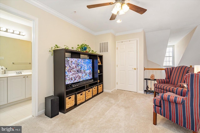 sitting room with light carpet, ceiling fan, sink, and ornamental molding