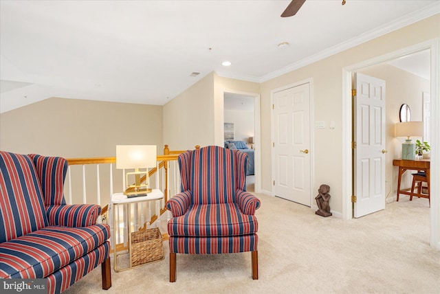 sitting room with ceiling fan, vaulted ceiling, crown molding, and light carpet