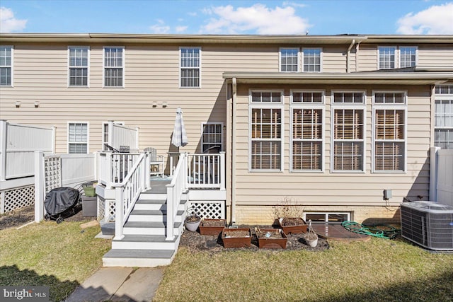 back of property featuring central AC, a yard, and a wooden deck