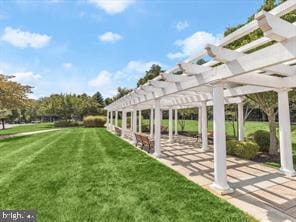 view of property's community featuring a pergola and a lawn