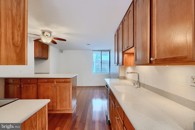 kitchen with ceiling fan, dark hardwood / wood-style floors, backsplash, dishwasher, and sink