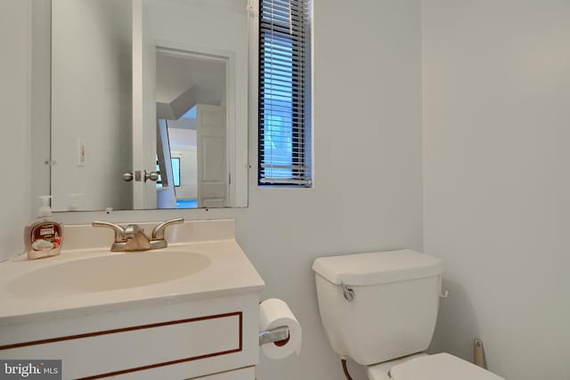 bathroom featuring toilet and vanity