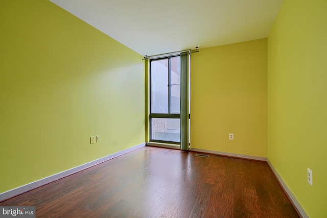 spare room with hardwood / wood-style floors