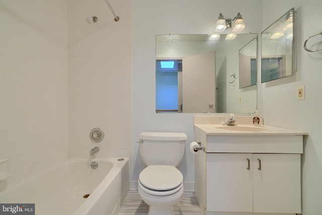 full bathroom with toilet, tiled shower / bath, hardwood / wood-style flooring, and vanity