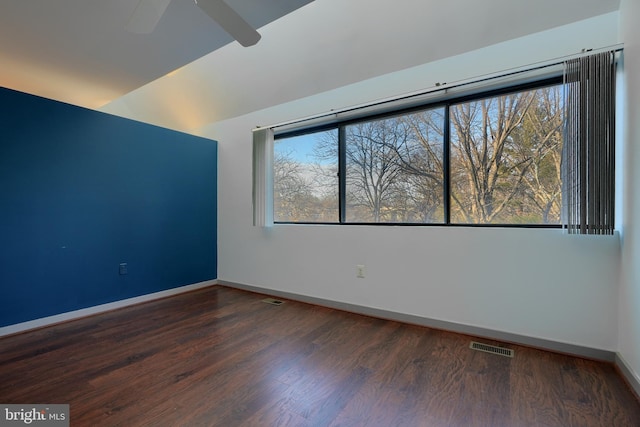 unfurnished room featuring ceiling fan and dark hardwood / wood-style floors