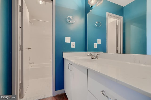 bathroom featuring vanity, shower / washtub combination, and hardwood / wood-style flooring