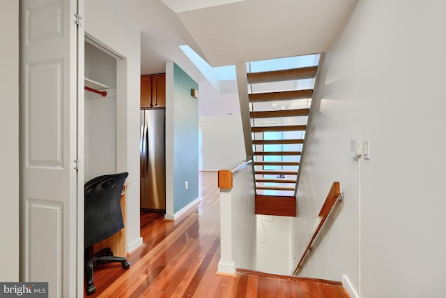 stairway featuring wood-type flooring