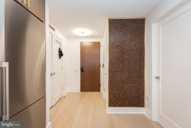 corridor with light hardwood / wood-style flooring