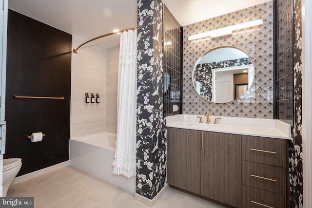 full bathroom with shower / tub combo, vanity, tile patterned floors, and toilet