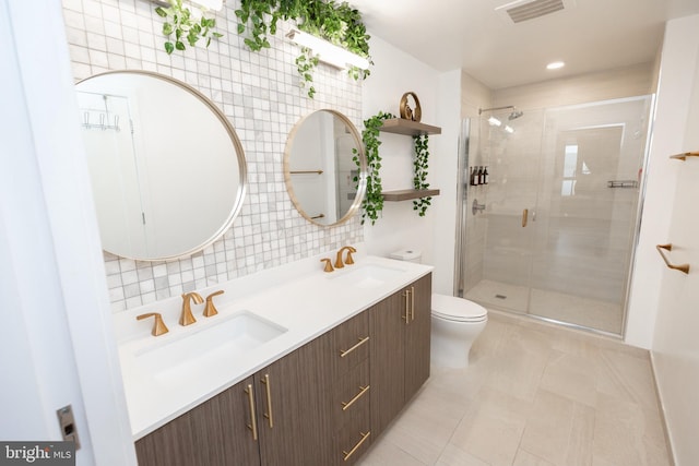 bathroom featuring tasteful backsplash, vanity, a shower with shower door, tile patterned floors, and toilet